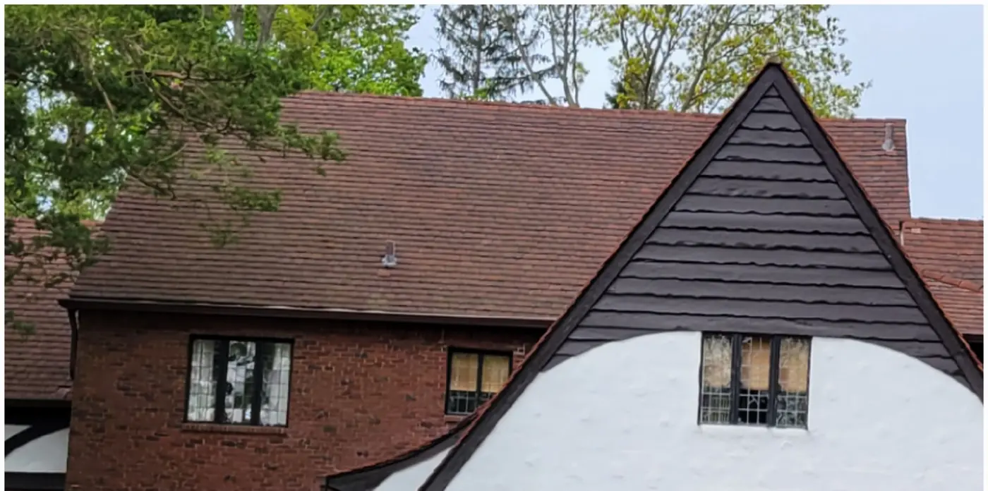 Tudor with a clay tile roof in Great Neck after slate cleaning