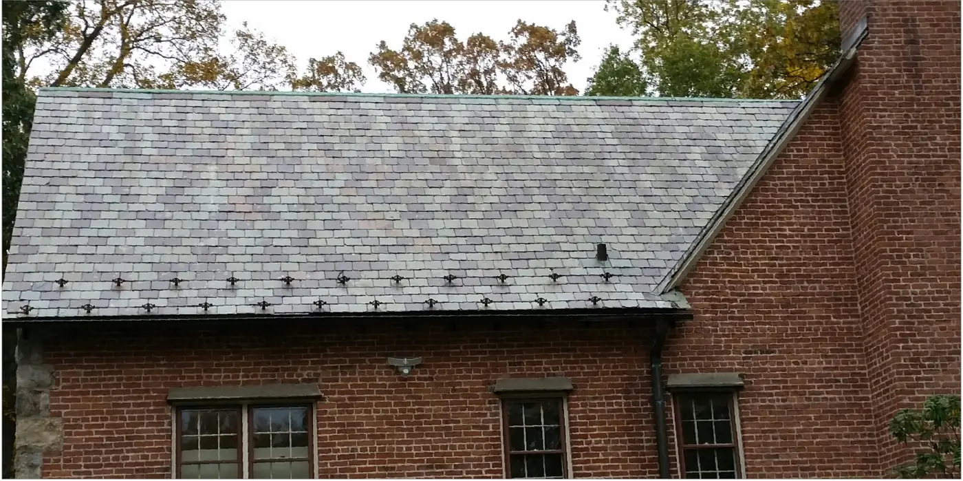 Side slope with snow guards in Huntington after slate cleaning