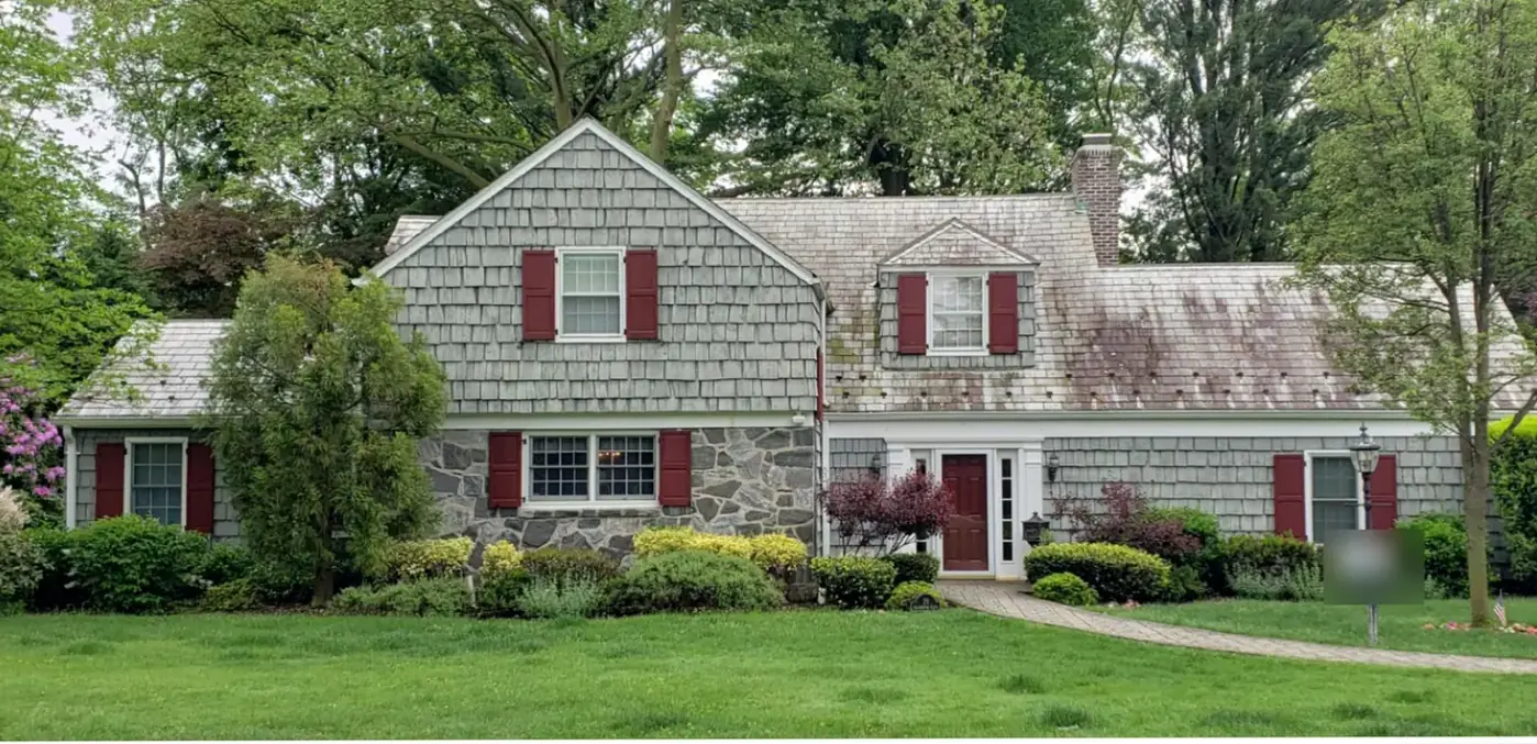 Classic colonial with snow guards in Port Washington before slate cleaning