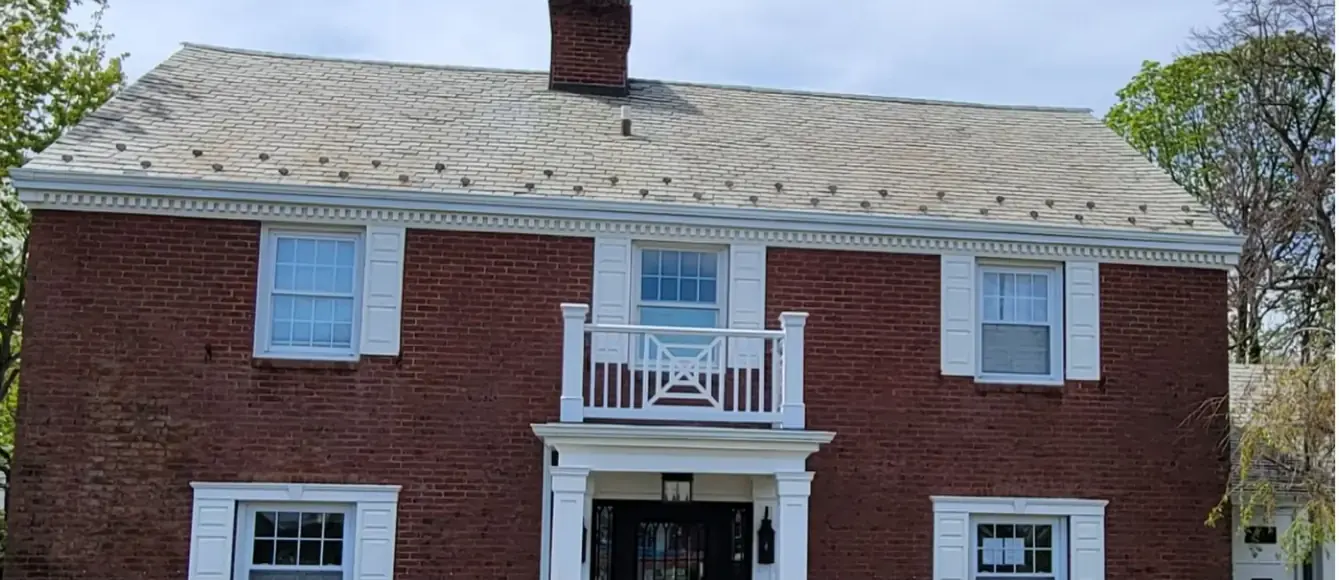 Brick colonial with snow guards in Rockville Centre after slate cleaning