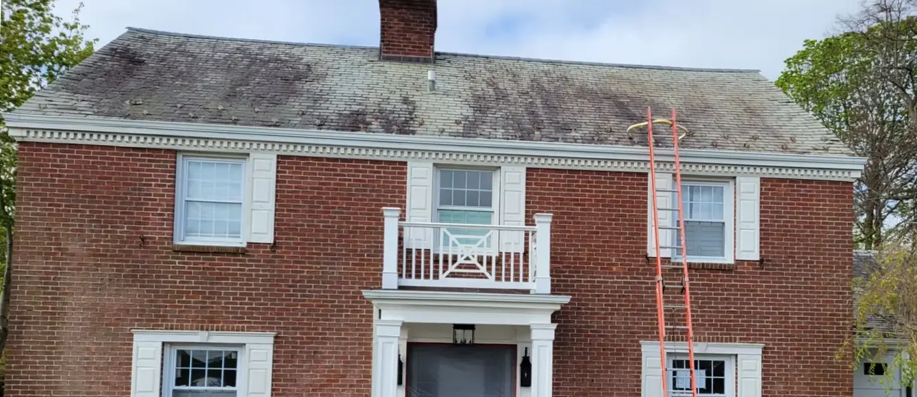 Brick colonial with snow guards in Rockville Centre before slate cleaning